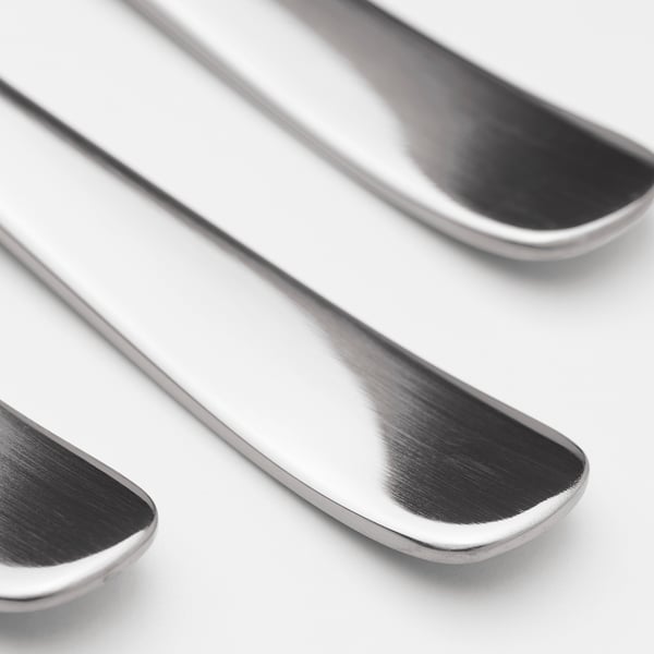 Three polished stainless steel spoons are neatly arranged, showcasing their sleek, durable design.