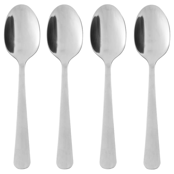 Four polished, silver stainless steel spoons in a neat row, identical in shape and design, suitable for table setting.