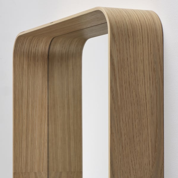 Wooden-framed mirror on wall, displaying elegant oak finish and subtle curves, reflecting high-quality design.