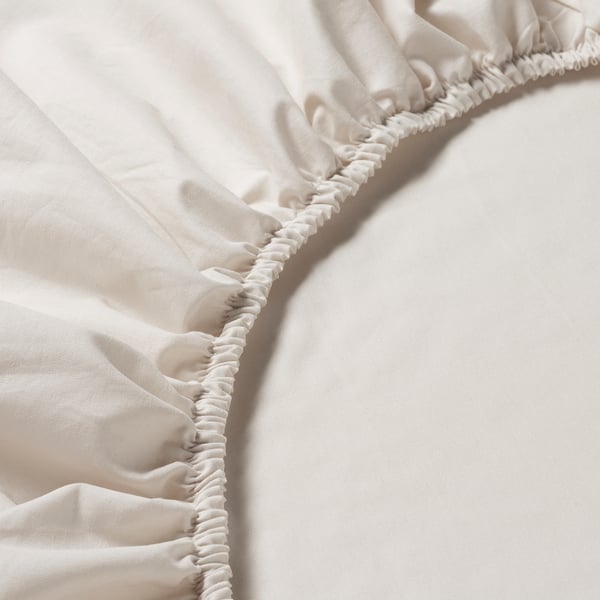 Close-up of fitted sheets elastic edge, showcasing quality stitching and soft fabric.