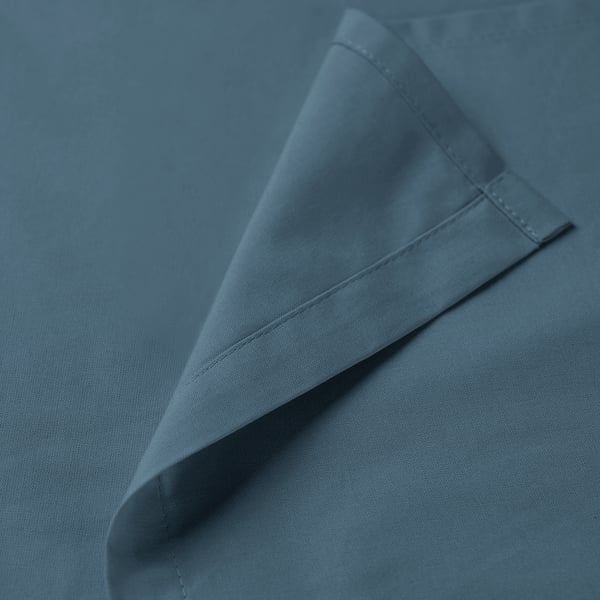 Folded blue fabric, neatly stitched, showcasing quality cotton texture and recycled thread.