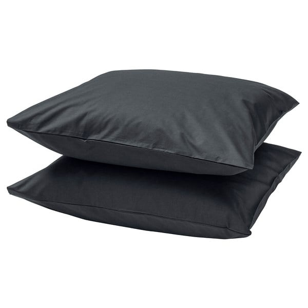 Two dark grey, plush square pillows stacked on each other.