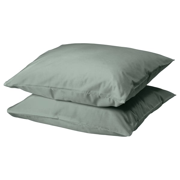 Two square-shaped DVALA pillows in grey-green, made of 100% cotton, stacked neatly.