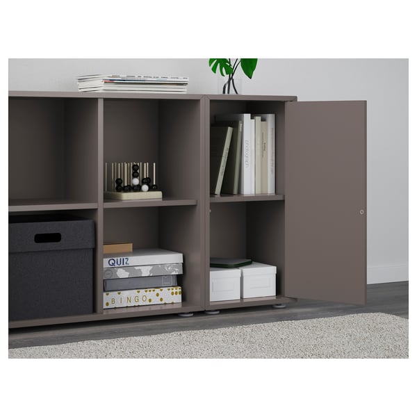 Grey EKET storage unit with adjustable shelves and open access compartments; one door partially open.