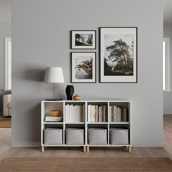 Minimalist living room with EKET storage, table lamp, and 3 framed nature photos.