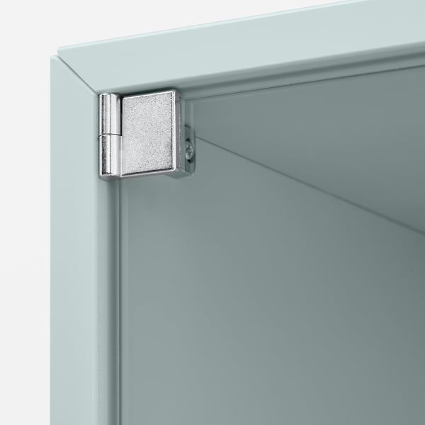Metal hinge attached to light blue cabinet corner.
