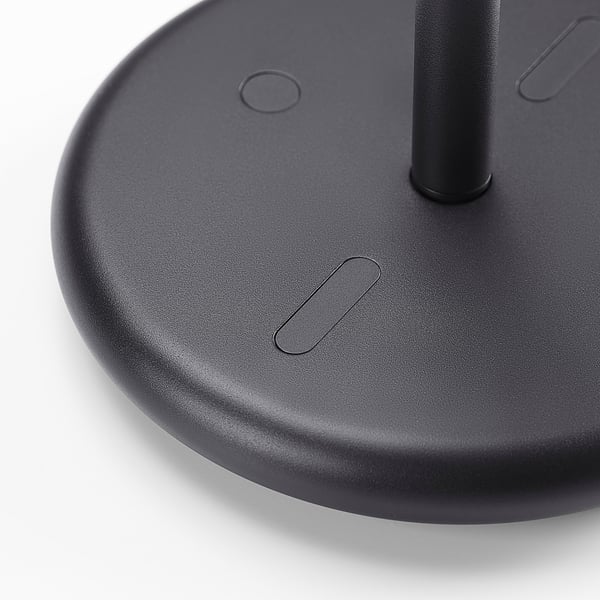 Black circular base of stylish table mirror with smooth texture and subtle design details.