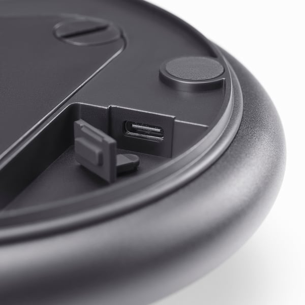 Close-up of a sleek black usb-c port on a compact device, emphasising its high-quality design and functionality.