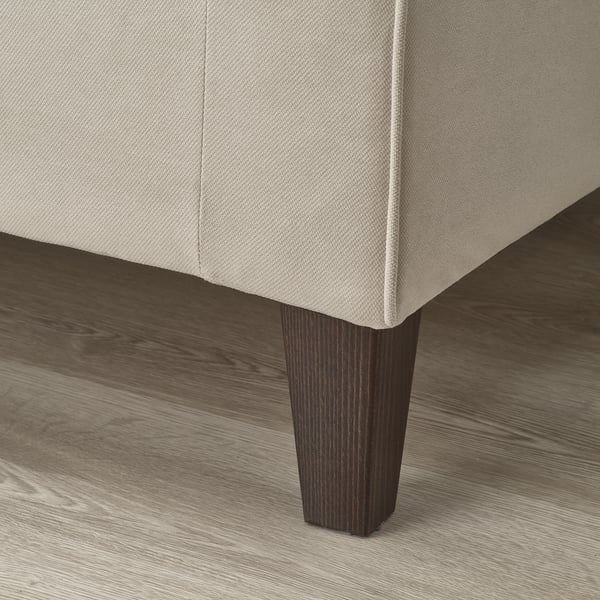 Close-up of modern sofa leg, robust wood finish, sleek design, reflects high-quality craftsmanship.