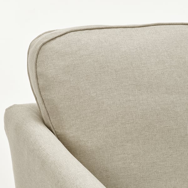 A close-up of a sleek, upholstered sofa corner, showcasing its soft, textured fabric and clean, well-crafted lines.