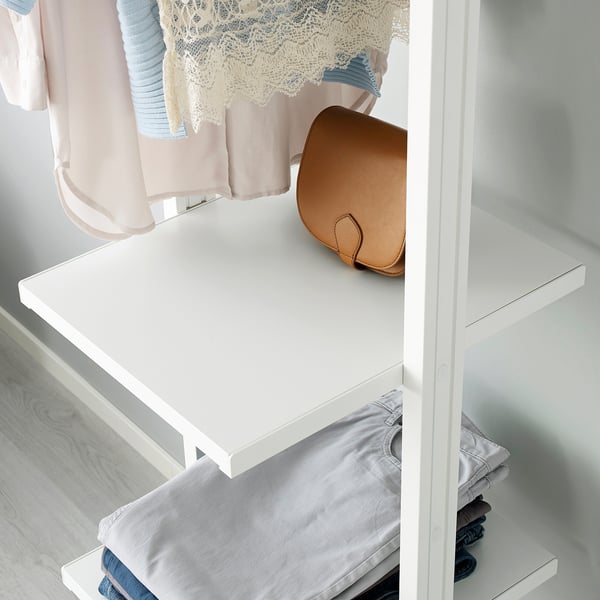 White closet shelf holding folded clothes and a brown purse, part of the ELVARLI system.