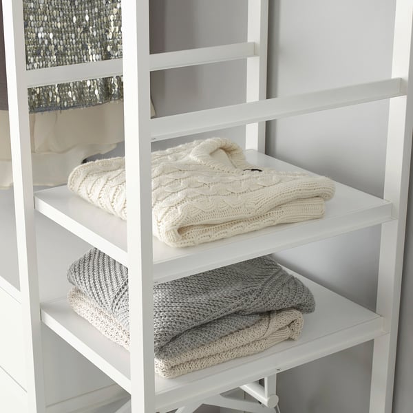 Folded blankets on adjustable white shelf. Easy to move and instal.