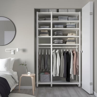 White ELVARLI wardrobe with shelves & hanging racks, beside king bed, modern minimalist design