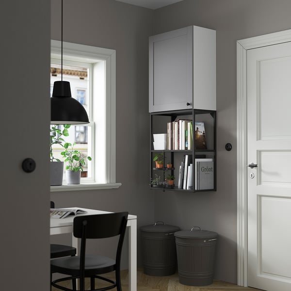 Grey ENHET wall cabinet with 2 shelves near window & door, above 2 black bins.