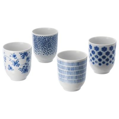 Four blue and white ceramic cups with floral and geometric designs.
