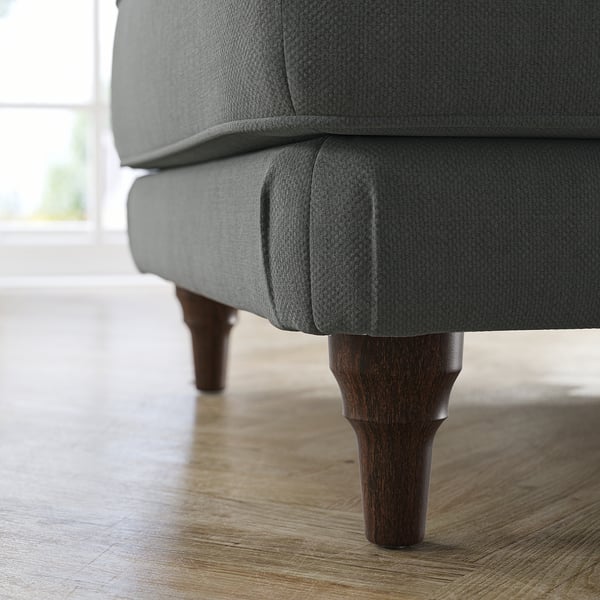 Close-up of grey ESSEBODA footstool on wood floor. Dark wood legs, cushioned seat.
