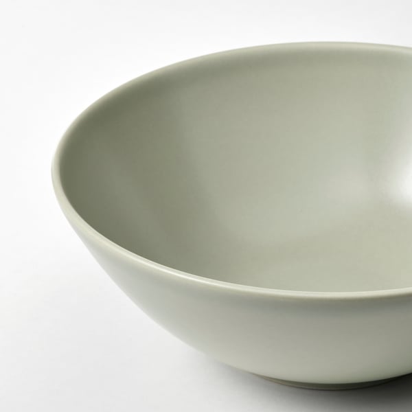 Large, greenish bowl with smooth, matte glaze on white surface.