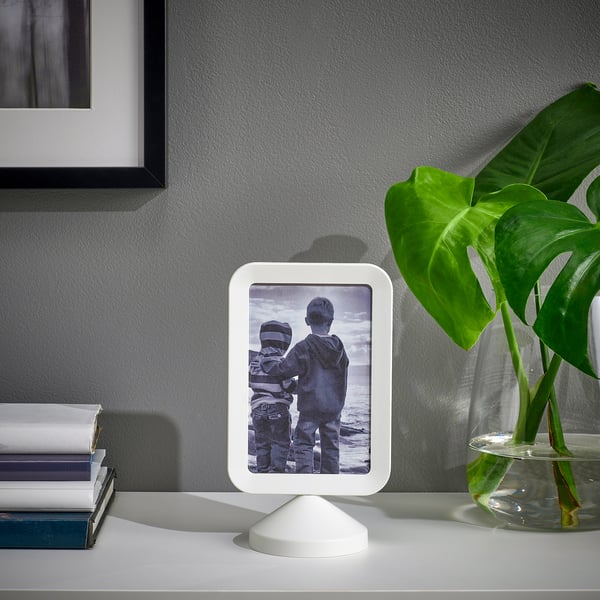 Frame with kids by water, books, and plant; double-sided photos