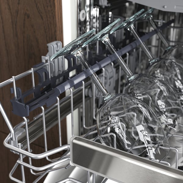 A dishwashers upper rack holds glassware securely with adjustable holders for space optimisation.