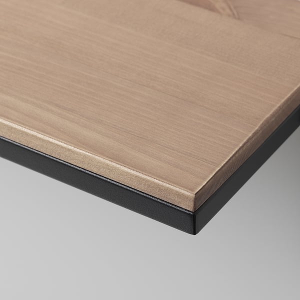 Close-up of rustic shelf edge, showing fine wood grain texture and smooth black metal frame.