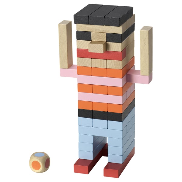 Fjällrävak building blocks figure in multicolor. Blocks are square and stacked to form a humanoid shape with a dice nearby.