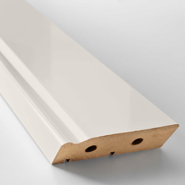 White kitchen plinth, smooth surface, slanted angle, light grey background, fiberboard and plastic.