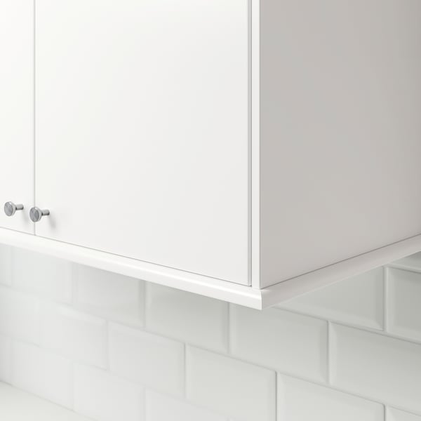 White cabinet with knobs and under-light.