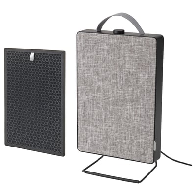 A black FÖRNUFTIG air purifier with a fabric front and a removable handle for portability. It stands on a metal stand.