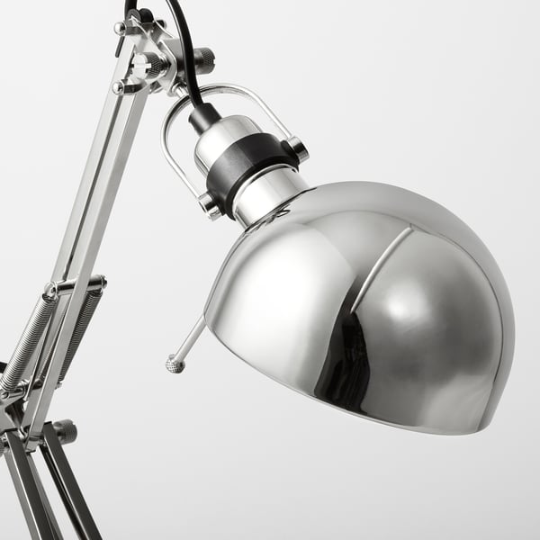 Adjustable metal desk lamp, shiny chrome finish; versatile design for reading, classic style.