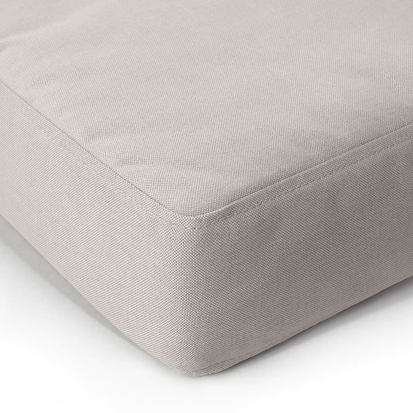 Close-up of soft, textured cushion, showcasing quality recycled fabric and meticulous stitching.