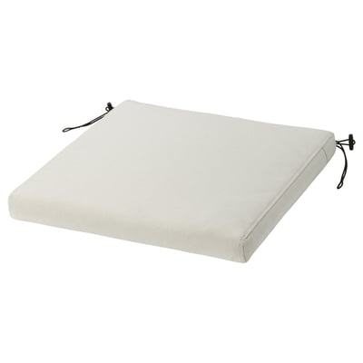 A light grey outdoor chair cushion with ties for a secure fit.