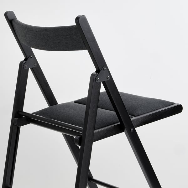 Black folding chair with sturdy wooden frame, padded seat and back for comfort. Ideal for small spaces.
