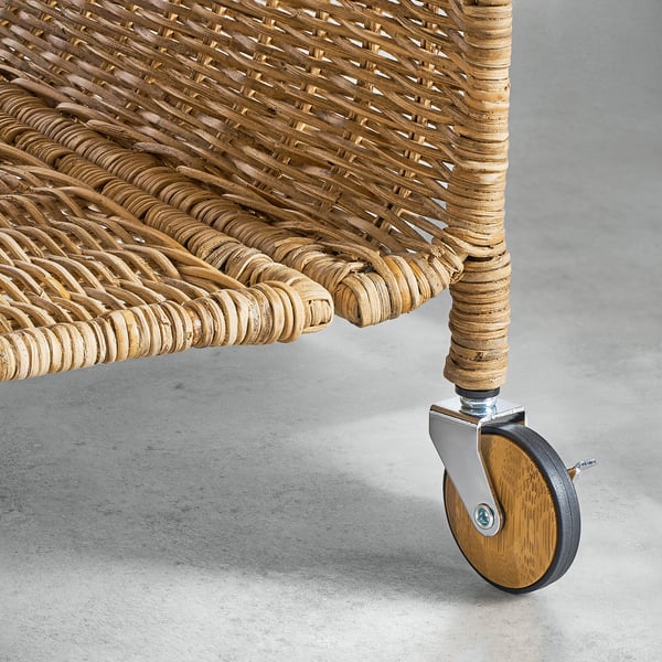 Handwoven rattan storage furniture with wheels and metallic castor, displaying craftsmanship and quality.