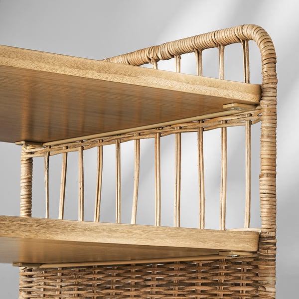 Natural rattan and eucalyptus shelf unit with intricate weaving, castors, and handles for portability.