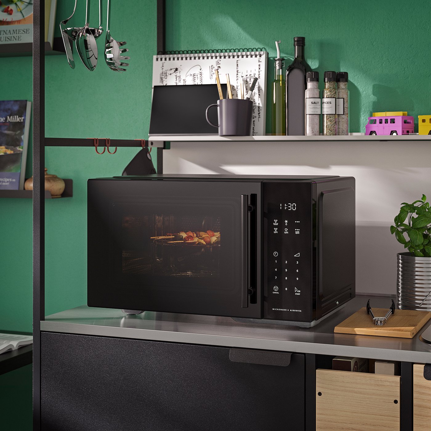 Black GÅTEBO microwave on grey counter, digital display 1:30, with kitchen items on top shelf.