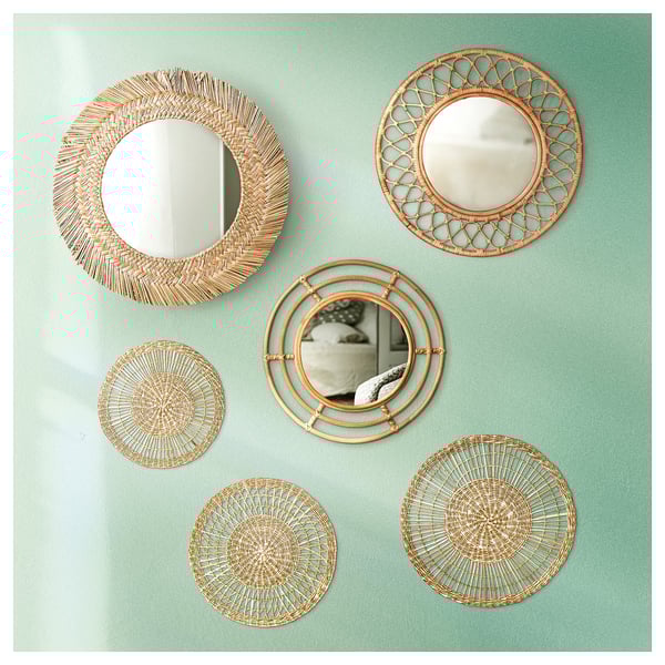 Six circular handmade mirrors, natural woven material, arranged on teal wall.