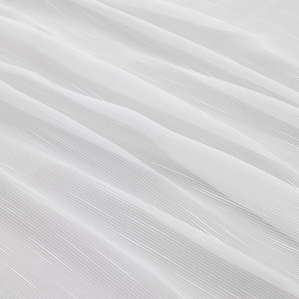 Elegant sheer curtains with delicate patterns, offering privacy and allowing soft daylight through.