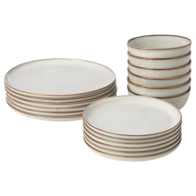 A stack of GLADELIG sandy-colored plates and bowls, made of stoneware, with a classic and decorative design.