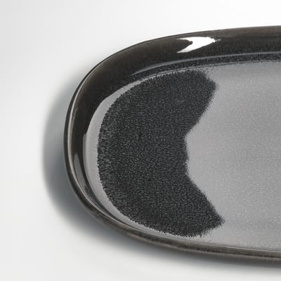Plated dark grey glazed plate with sleek, glossy surface.