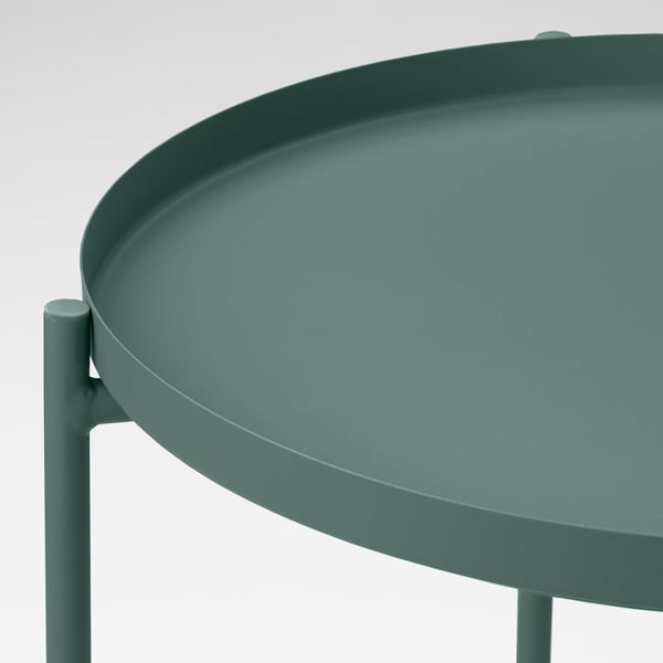 Modern, green round tray table with smooth surface and sturdy legs for stability; ideal for serving and easy to move.