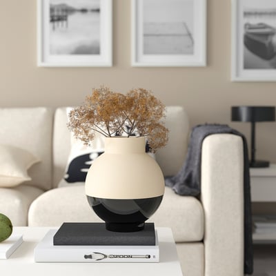 GLANSGRAN vase: matte beige top, glossy black base, holding dried flowers on table.