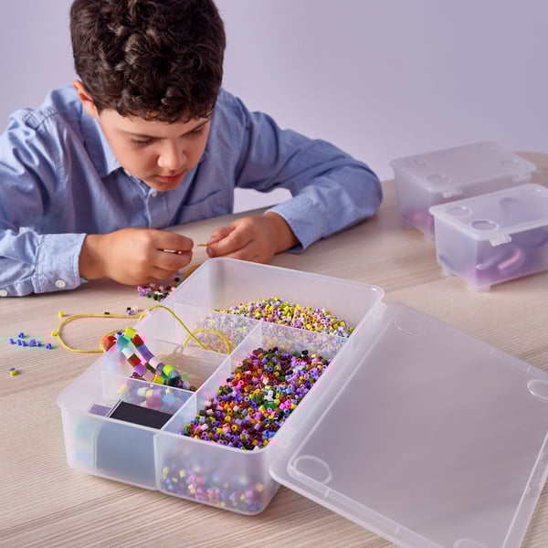 Boy crafting bead jewellery with GLIS box.