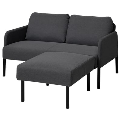 Dark gray modern sofa with matching ottoman, sleek metal legs, and clean lines.