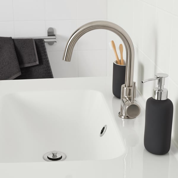 Modern bathroom sink with GLYPEN stainless steel tap, black accessories, sleek design.