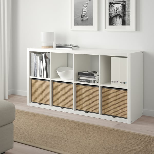 White GNABBAS seagrass storage box on shelf, smaller than books, between framed photos.