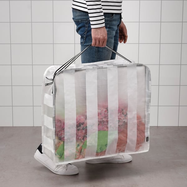 Person holding transparent storage case with vertical white stripes, ideal for storing and carrying items.