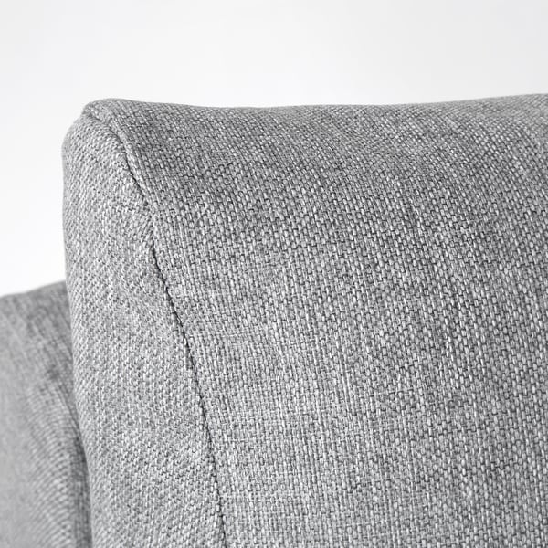 Close-up of a grey, soft, upholstered sectional cushion.