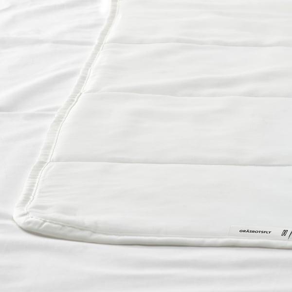 Close up of smooth, white duvet with subtle stitching, showcasing high-quality fabric.