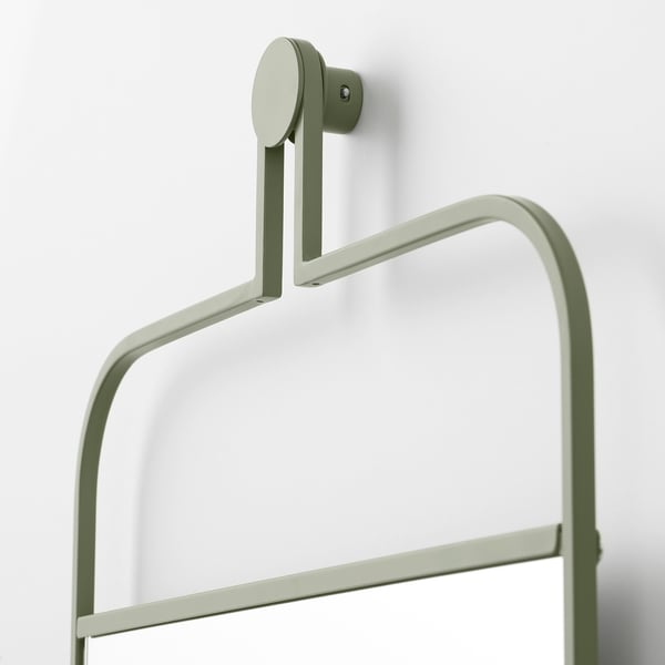 Sleek sage green wall-mounted mirror with rail for hanging accessories. Modern design, sturdy construction. Perfect for bedrooms or hallways.