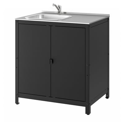 The GRILLSKÄR outdoor sink, black in colour with a stainless steel top, double doors for storage, and a sleek, modern design.